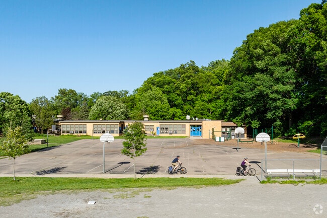 The play area behind Eberwhite Elementary features a paved bike path that connects to the woods.