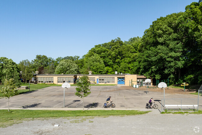 The play area behind Eberwhite Elementary features a paved bike path that connects to the woods.