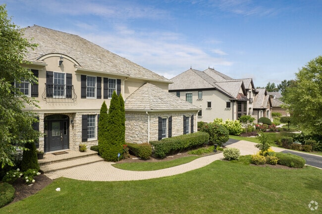 Manicured lawns and lush foliage line the streets of Green Oaks, Illinois.