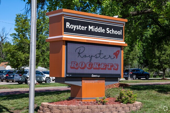 There is a sign for Royster Middle School near the main road.