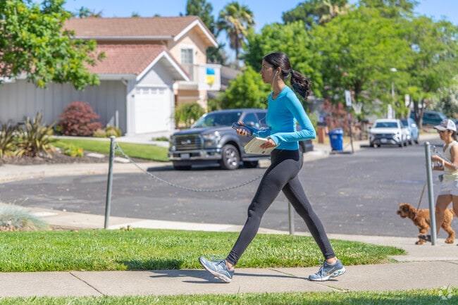A young woman walks along the many trails around the Midtown Concord neighborhood.