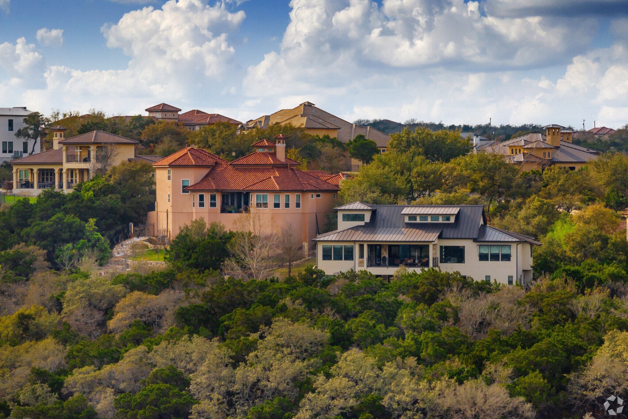 Mansions are found on a secluded hill in Cedar Creek, Grey Forest, TX.