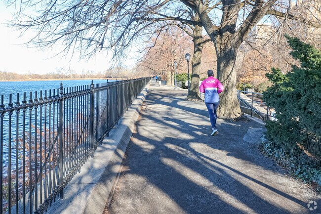 Locals exercise along Central Park's reservoir near Carnegie Hill.