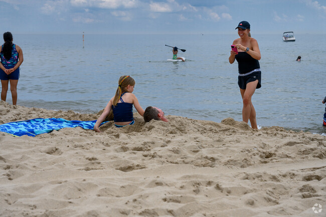 A family plays in the sand along Lake Michigan at Tunnel Park, north of Westside.
