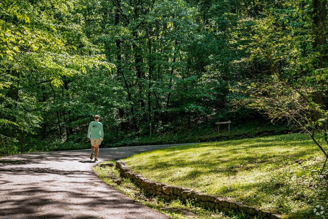 A person walking on the greenway at Percy Warner Park near the Harpeth Valley Park Neighborhood.