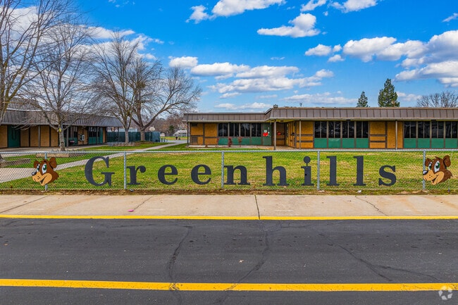Greenhills Elementary School sign lines the entrance fence.