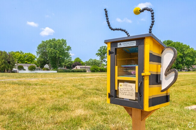 A little free library painted like a bee at Hanby Elementary School.