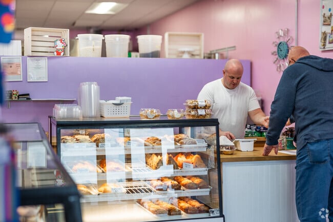 The owner of Tater Cakes Bakery serves a customer.