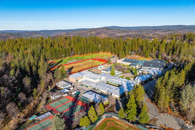 Colfax High School in Auburn, CA is surrounded by mature pine trees.
