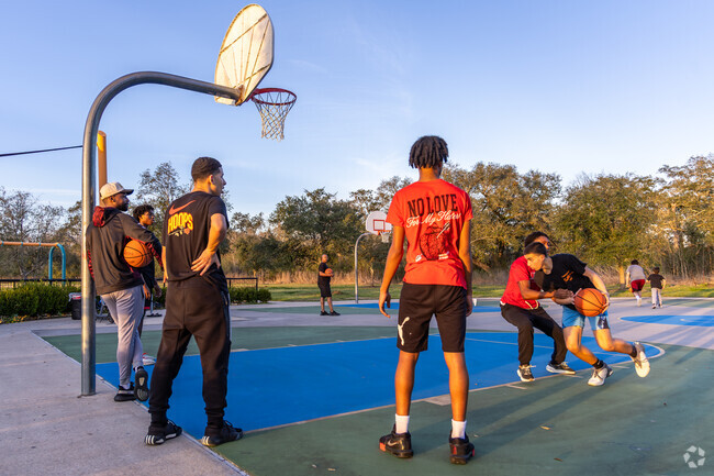 Iowa Colony residents enjoy a game of basketball at the local City Park at Meridiana.