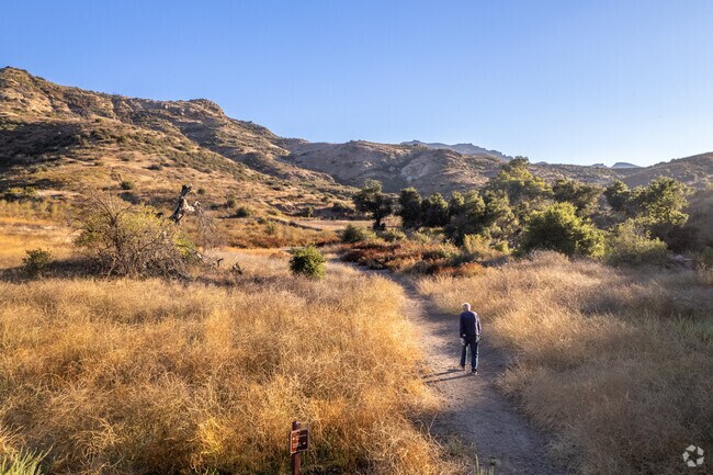Hike through miles of grasslands with shade trees throughout at Triunfo Creek Park in Westlake.