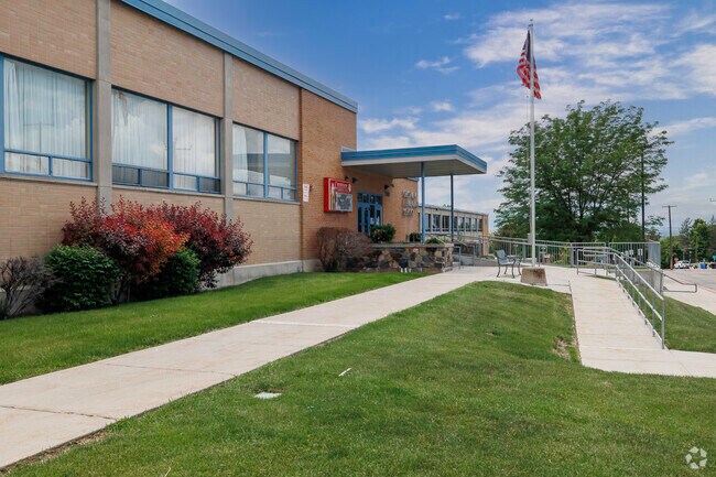 A bench, American flag and custom stonework add beauty to Crestview Elementary School.