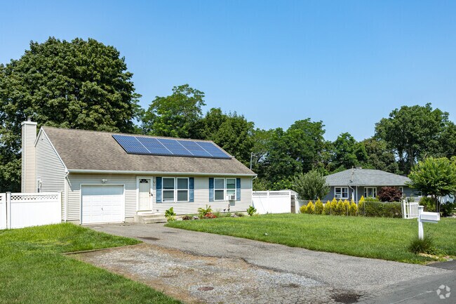Some of the newer Cape Cod style homes in North Bellport have solar panels on their roofs.