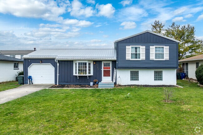 A split level home in Clinton Estates features a well manicures front yard.