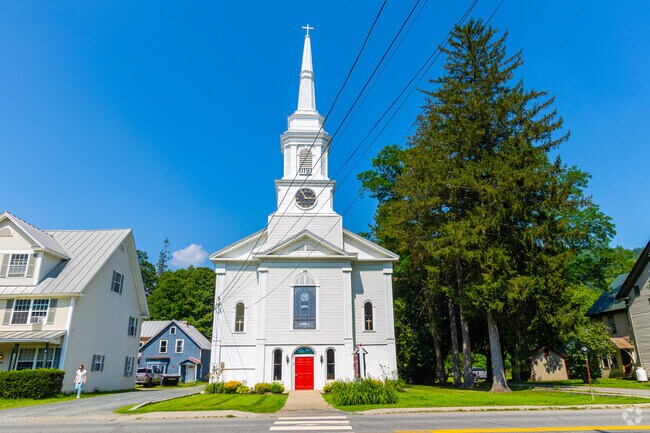 A historic church in South Royalton stands out with its tall steeple and red door.