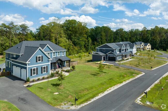 Large modern homes with multi-car garages line the streets of Burke Centre.