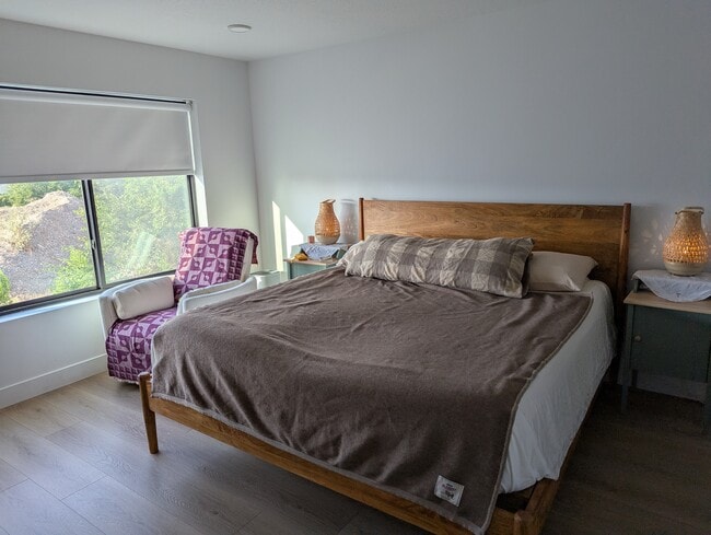 master bedroom with ensuite bathroom wood finished floors and recessed lighting
