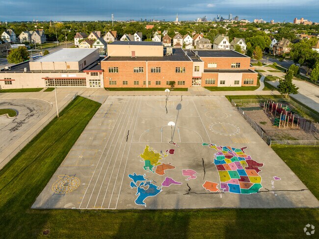 The recess area behind the school features colorful art.