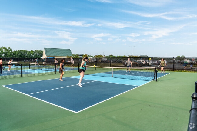 Pickleball enthusiasts enjoy a game on one of six courts at Sandhill Fields.