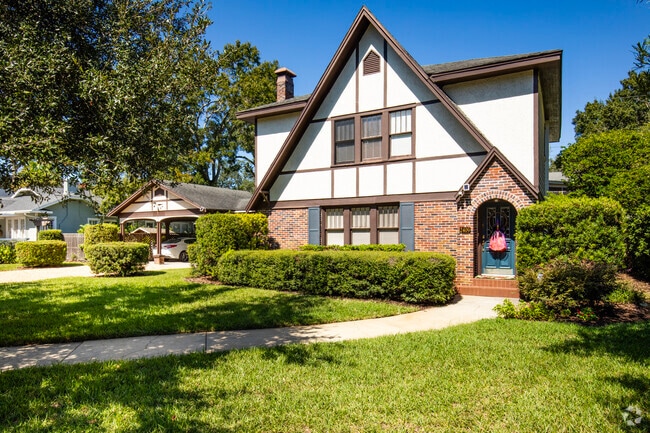 This beautiful Tudor Revival style home sits on a large lot in New Suburb Beautiful.