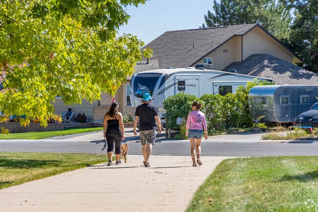 A family takes their dog on an afternoon stroll near the Shoenberg Farms neighborhood.