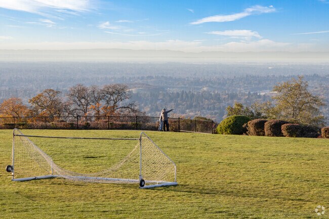 Nearby residents walk around Kalithea Park and stop for the view.