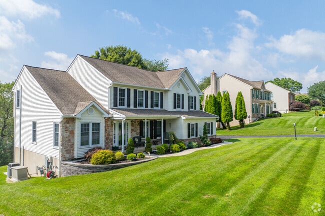Escape the summer heat in Birmingham Township under the covered front porch on a new traditional home.