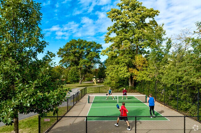 Residents play pickleball during the day at Belgium Town Park in Southwest St Charles.