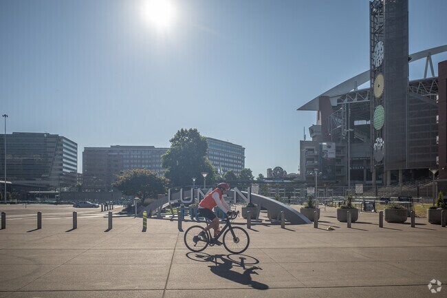 A cyclist pedals Lumen Field in the Pioneer Square neighborhood in Seattle.