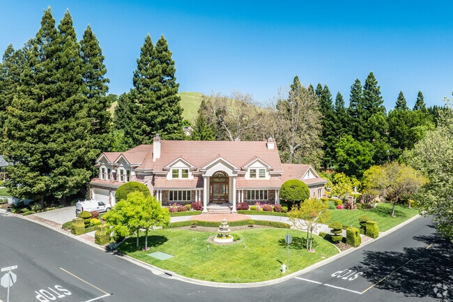 This large home sits on the corner of a neighborhood within Blackhawk with manicured yard.