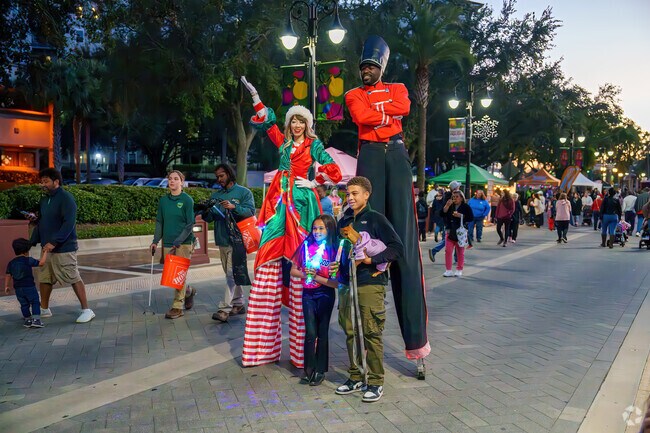 Children gather for photos with entertainers at Light Up the Holidays in Altamonte Springs.