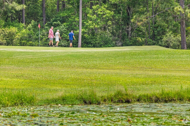 A group of golfers walks the lush green course in Boiling Spring Lakes.