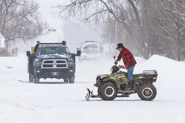 A Shepherd resident makes quick work out of removing snow with his quad.