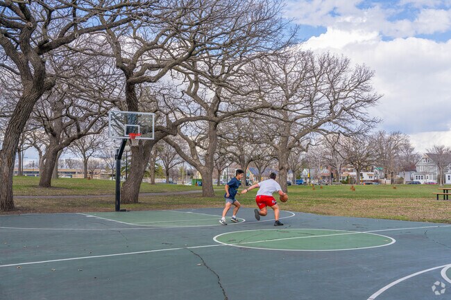 people enjoy a game of basketball in Beltrami Park.