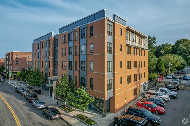 Apartment style building with parking lot in Lower Roxbury.