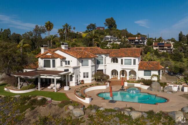A stunning Spanish mansion overlooks the hillside of Lake Hodges.