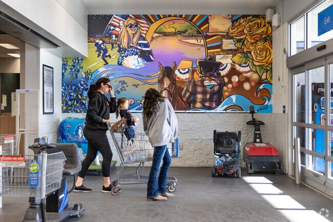 The Walmart Supercenter in Grape Creek welcomes shoppers with a bright mural.