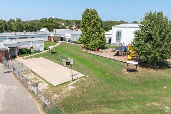 Cement Elementary offers students a playground and basketball court.