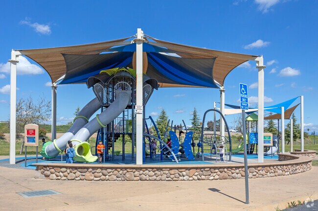 Kids enjoy the covered playground at Martin Ray Reilly Park in Fresno.