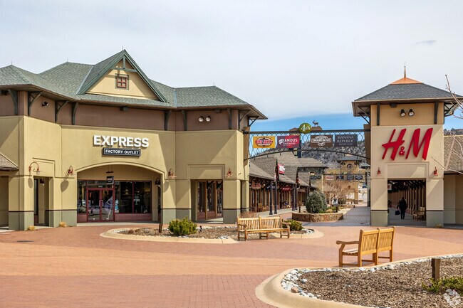 Shop at clothing stores like H&M in the Outlet Mall which is near The Meadows neighborhood.