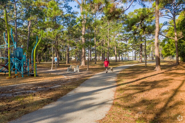 A resident walking their pet on the trail of Caloosa Park in Boynton Beach, FL.
