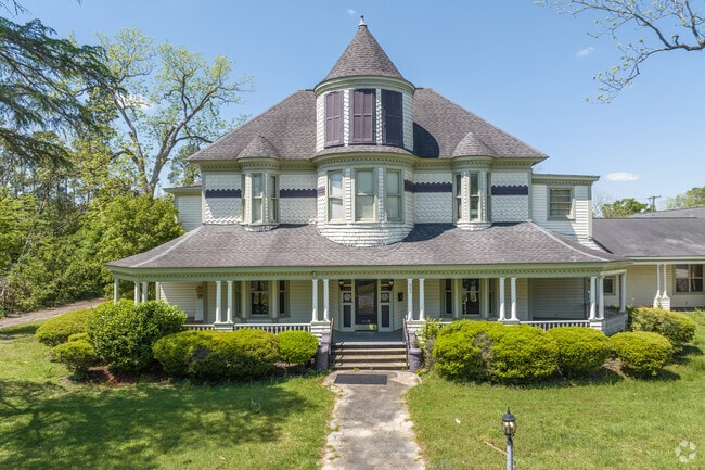 Large Queen Anne style homes sit back on lots with well maintained landscaping in Fitzgerald.