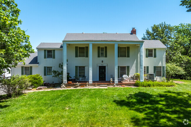 Large 2 story colonial style homes on 1 acre of land sit proud on hillsides in Platte Woods.