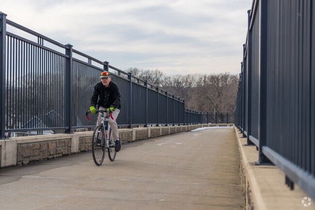 A person rides a bike on the path near Arrowood Park in Newport.