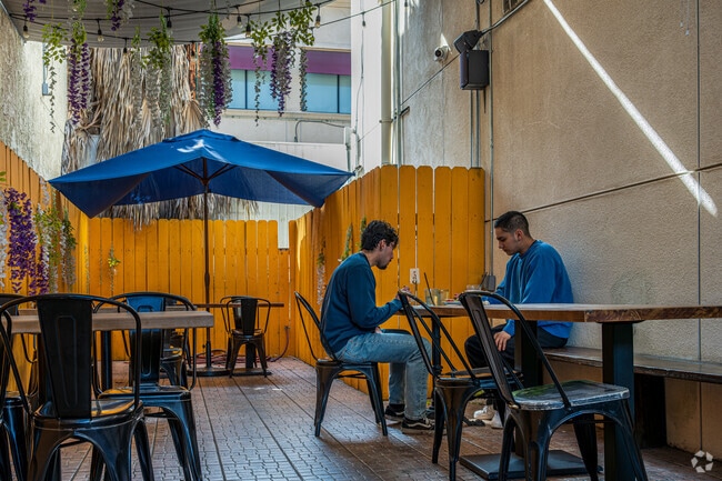 People enjoying a meal on the outdoor patio at Popping Yolk Cafe in Hacienda Heights