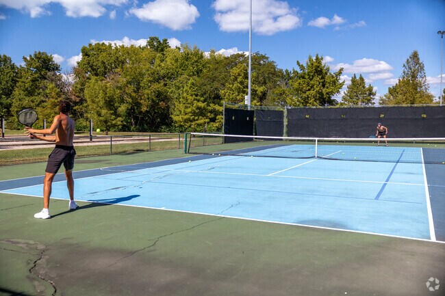 Enjoy a game of tennis with your friend at King's Meadow's Cosmopolitan Park.