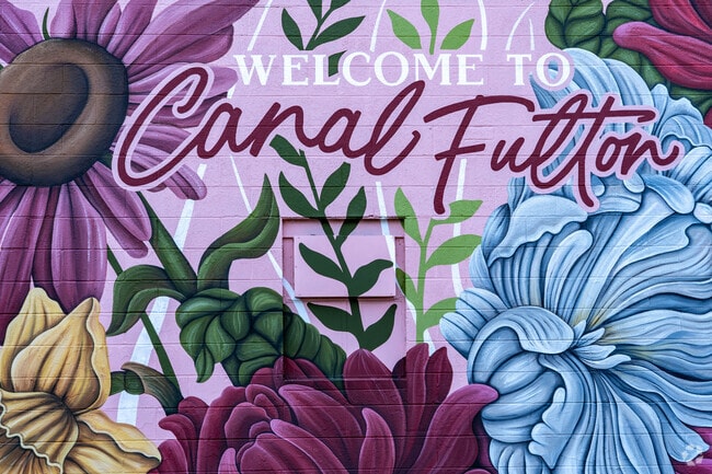 A mural welcoming visitors to Canal Fulton adorns the side of a building along the Ohio and Erie Canal in Canal Fulton, Ohio.