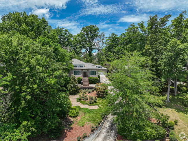 A stunning waterfront home in Lakemont shaded by mature landscaping.