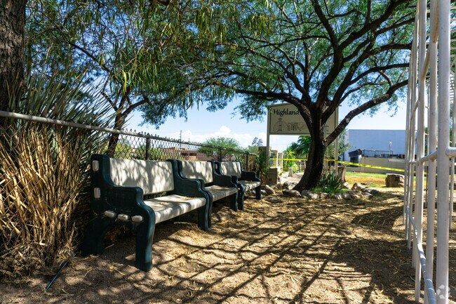 Seating in the shade is behind the the playset at Highland Free School in Barrio San Antonio
