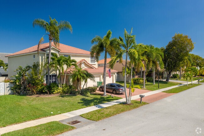 Palm trees adorn these beautiful homes in the Plantation Acres neighborhood of Sunrise, FL.